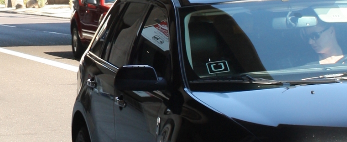 Uber logo in a car window.