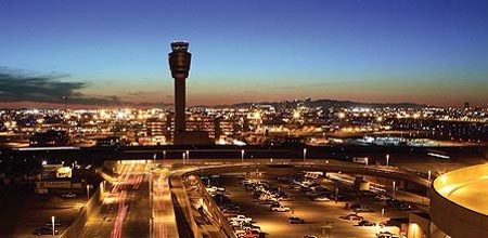 Overview shot of PHX Sky Harbor International Airport and its air traffic control tower at night. City of Phoenix Aviation Department Files Legal Action Against Tempe