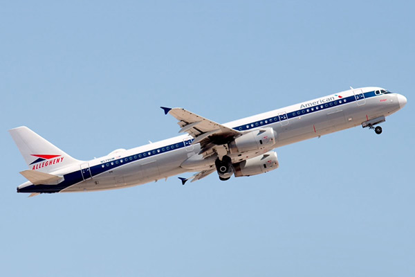 Allegheny Airlines plane with retro livery flying against a blue sky